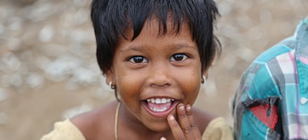 A little girl smiles at a dinner outreach in India hosted by Mission to Children.