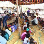 A feast commences with rows of children and plates of food at this Christmas outreach in India.