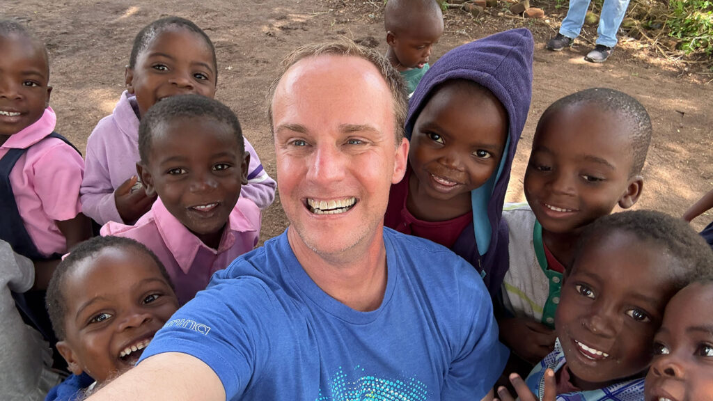 Mission to Children's CEO Byron Garmo with children at the Songa childcare center, a collaobration with Save Orphans Ministries.